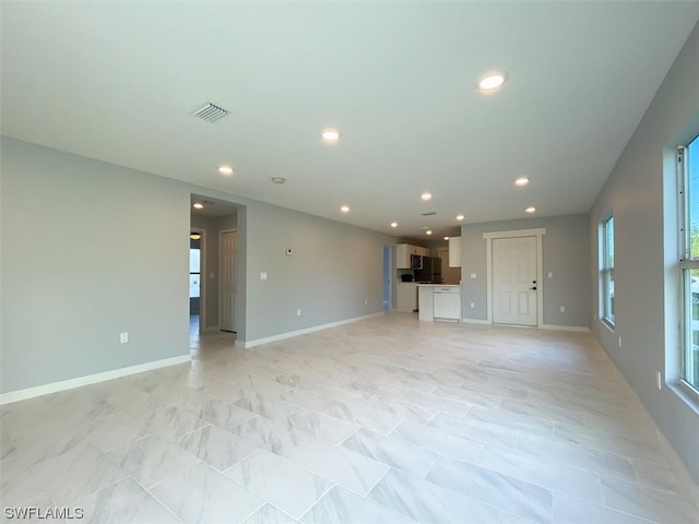 unfurnished living room with light tile flooring