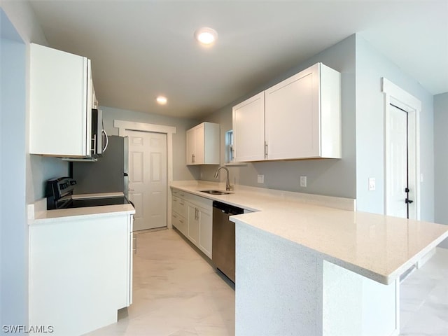 kitchen with light stone countertops, appliances with stainless steel finishes, sink, light tile floors, and white cabinets