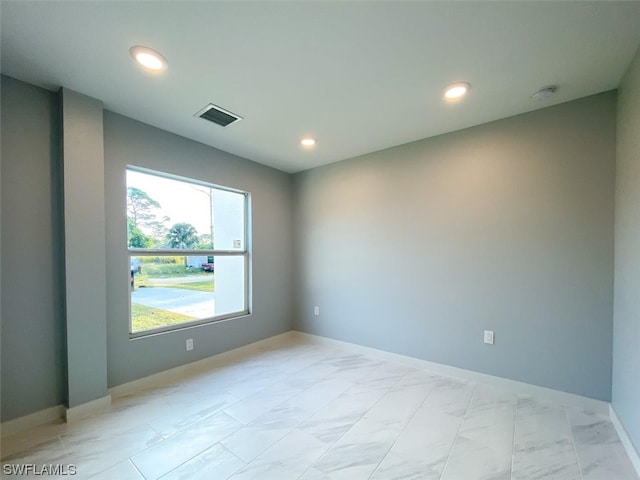 unfurnished room featuring light tile flooring