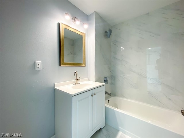 bathroom featuring tiled shower / bath and vanity