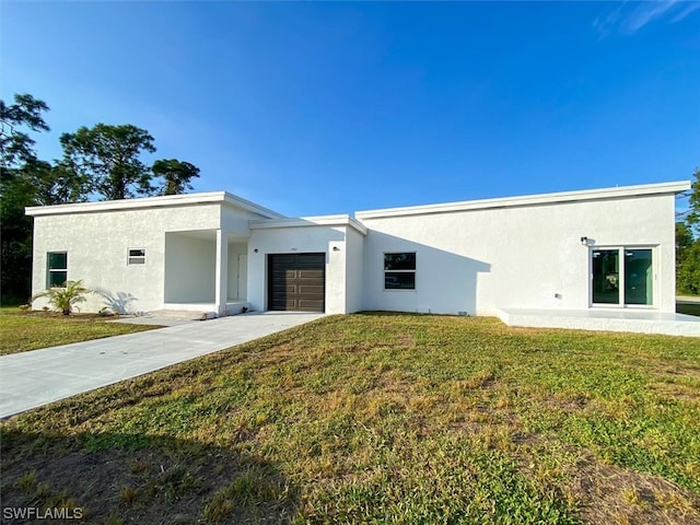 view of front of house with a front yard and a garage