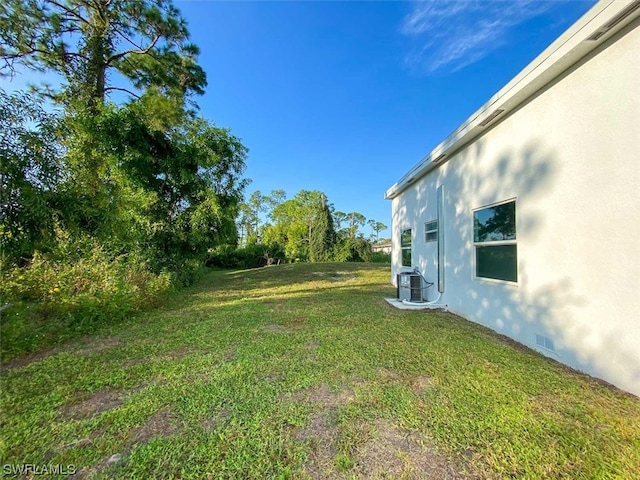 view of yard with central AC unit