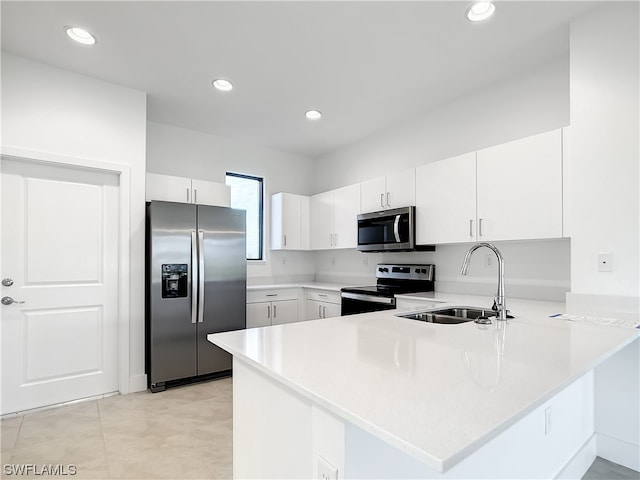 kitchen featuring white cabinetry, light tile flooring, appliances with stainless steel finishes, and sink