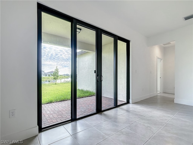 doorway with light tile floors