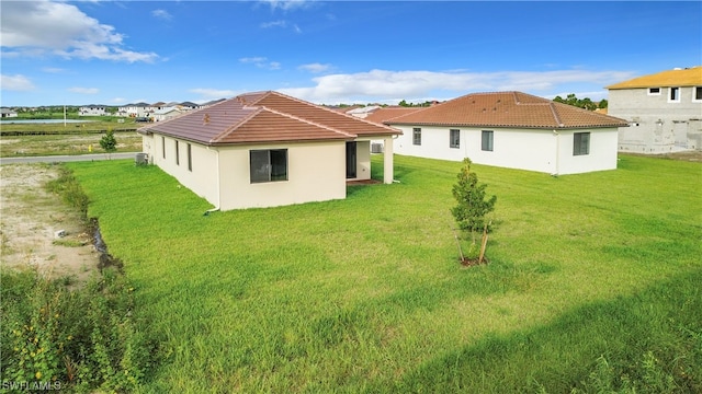 rear view of house with a yard