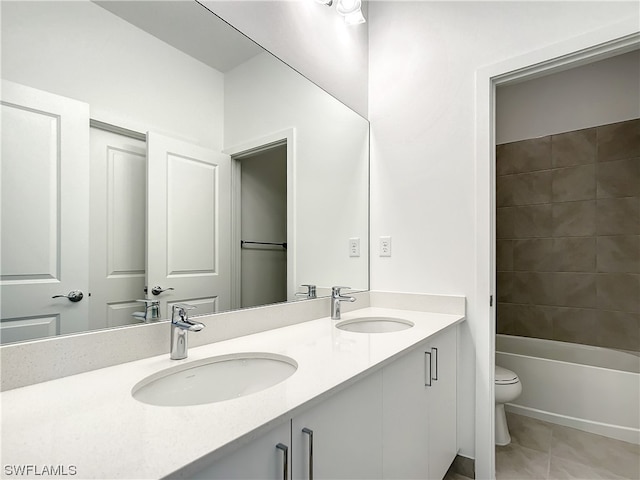 full bathroom featuring  shower combination, tile floors, double vanity, and toilet