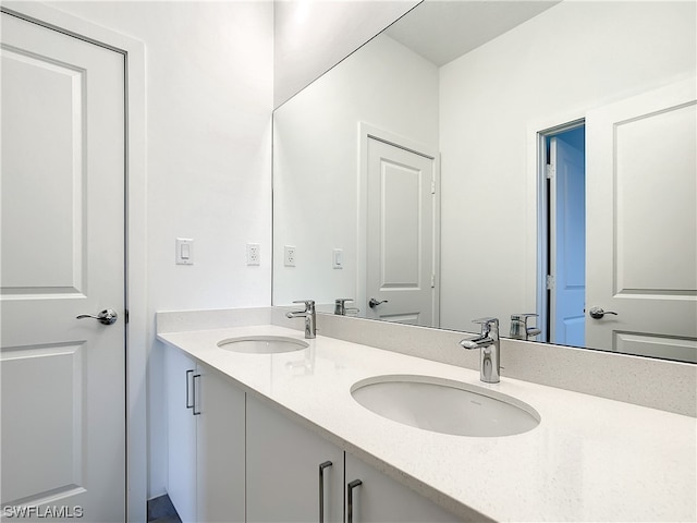 bathroom featuring double sink and vanity with extensive cabinet space