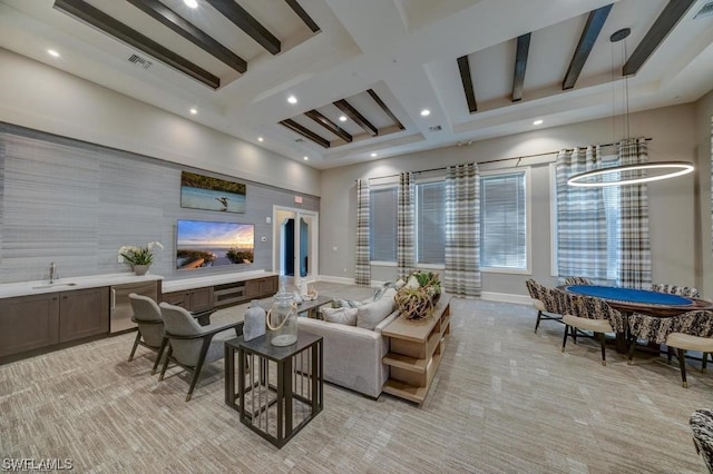 carpeted living room with an inviting chandelier, coffered ceiling, and beamed ceiling