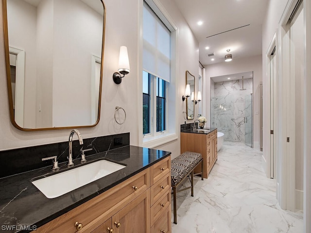 bathroom with tile flooring, vanity, and a tile shower