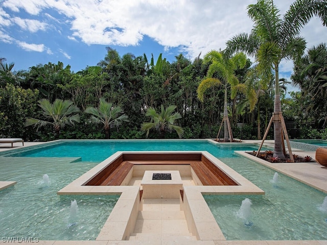 view of swimming pool with pool water feature