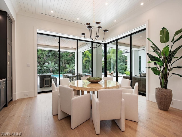 dining room featuring plenty of natural light, a chandelier, and light wood-type flooring