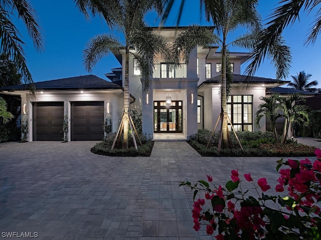 mediterranean / spanish-style house with french doors and a garage