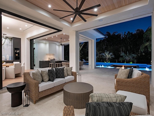 patio terrace at night with ceiling fan and outdoor lounge area