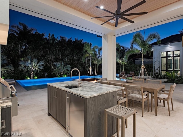 view of terrace featuring ceiling fan and sink