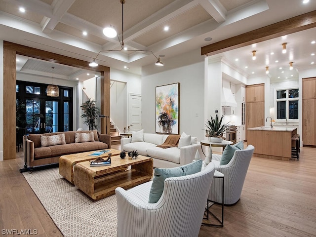 interior space featuring coffered ceiling, sink, beam ceiling, and light hardwood / wood-style floors