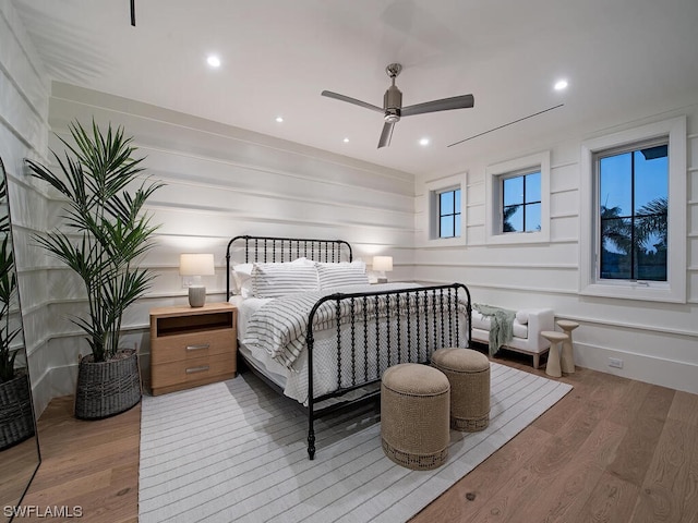 bedroom with ceiling fan and hardwood / wood-style flooring