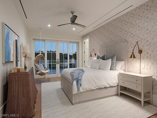 bedroom featuring ceiling fan, access to outside, light wood-type flooring, and french doors