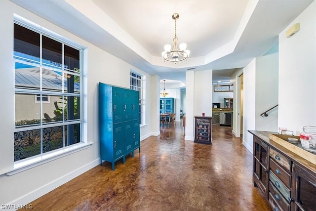 foyer featuring a raised ceiling, a notable chandelier, and beverage cooler