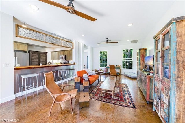 living room with sink and ceiling fan