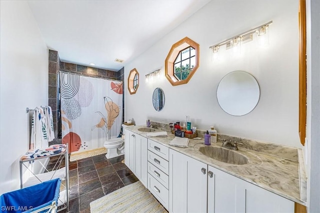 bathroom featuring toilet, vanity, and walk in shower