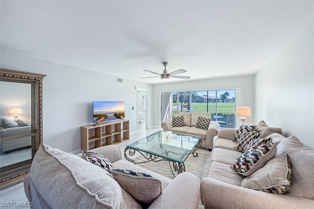 living room with ceiling fan and light wood-type flooring