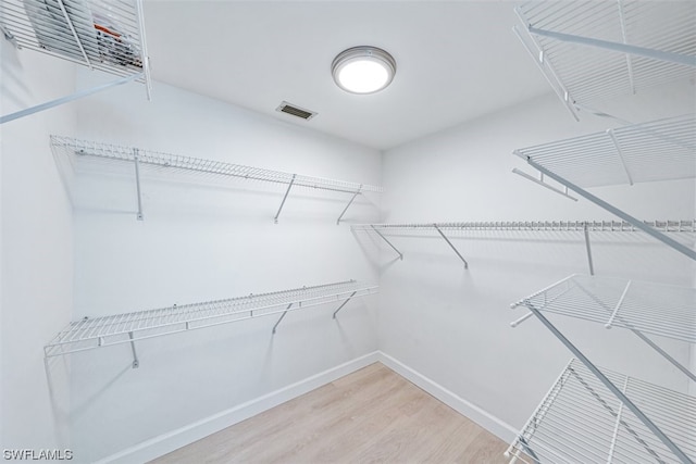 walk in closet featuring light hardwood / wood-style floors