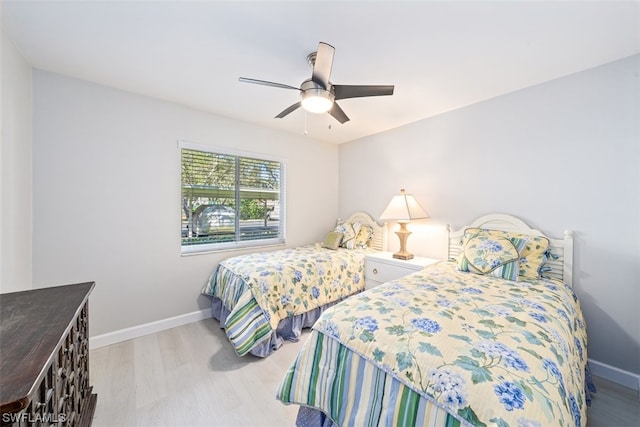 bedroom with ceiling fan and light hardwood / wood-style flooring