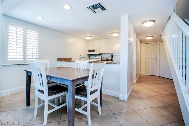 tiled dining room with sink