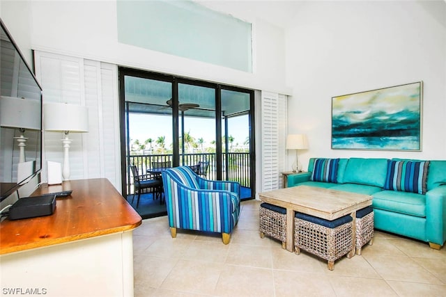 living room featuring light tile floors and a towering ceiling