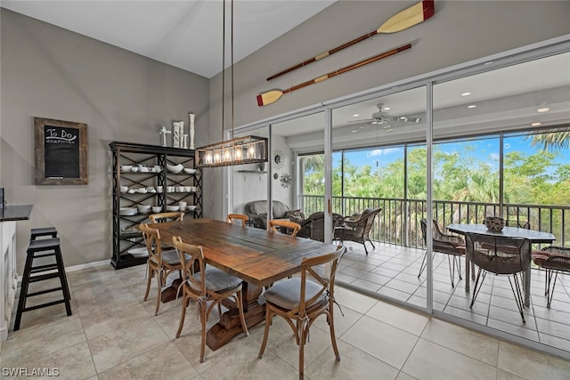 dining space with ceiling fan and light tile patterned floors