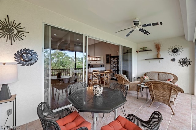 sunroom featuring ceiling fan