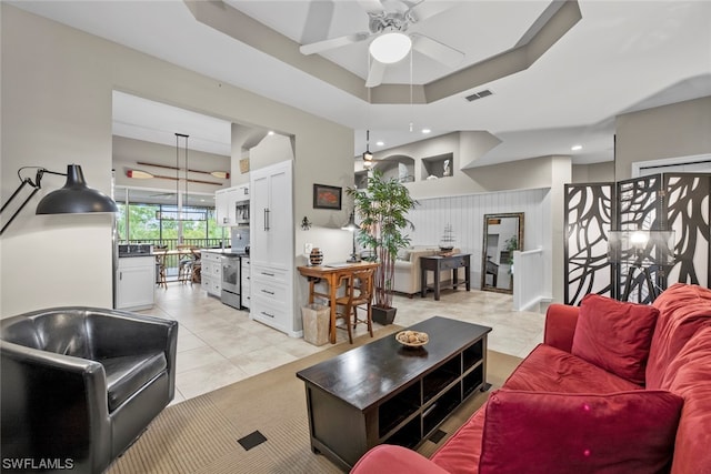 tiled living room featuring ceiling fan