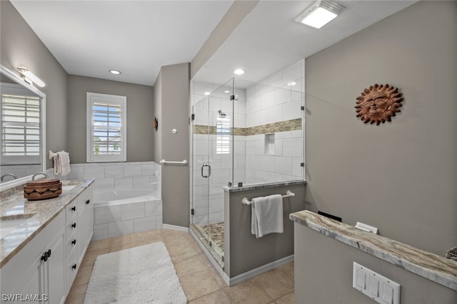 bathroom featuring independent shower and bath, vanity, and tile patterned floors