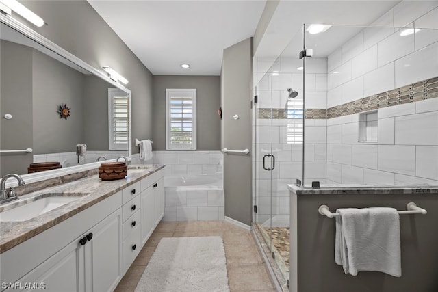 bathroom featuring vanity, shower with separate bathtub, and tile patterned floors