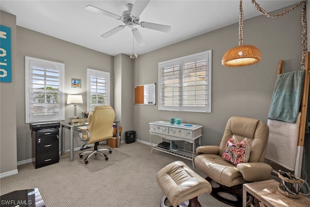 office space with ceiling fan and light carpet