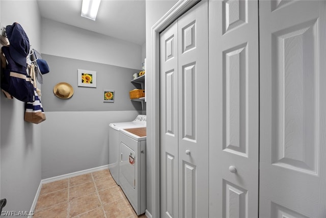 washroom with light tile patterned flooring and washer and dryer