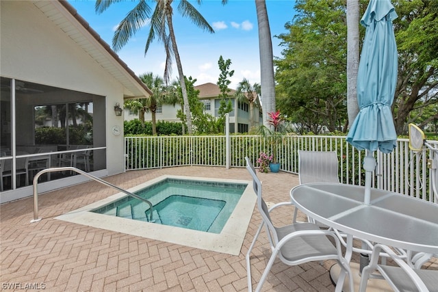 view of swimming pool with a sunroom and an in ground hot tub