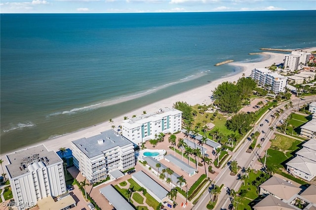 drone / aerial view featuring a beach view and a water view