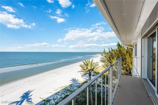 balcony with a view of the beach and a water view