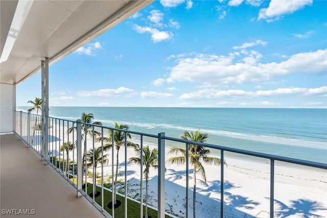 balcony featuring a water view and a view of the beach