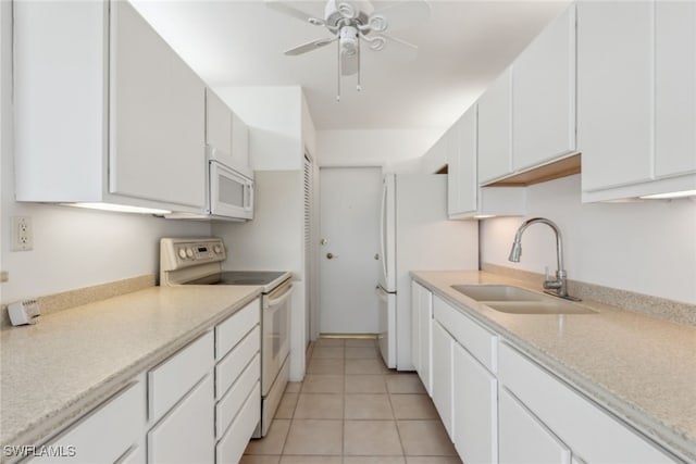 kitchen with white appliances, light tile patterned floors, sink, ceiling fan, and white cabinets