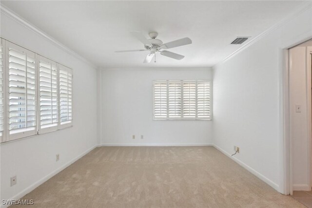 spare room with a healthy amount of sunlight, ceiling fan, and ornamental molding