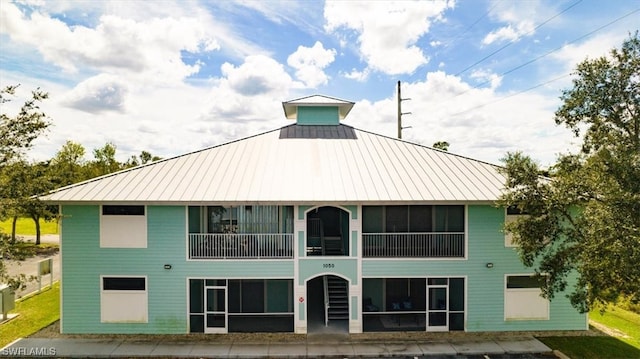 rear view of house featuring a balcony and a patio area