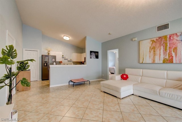 tiled living room featuring high vaulted ceiling and a textured ceiling