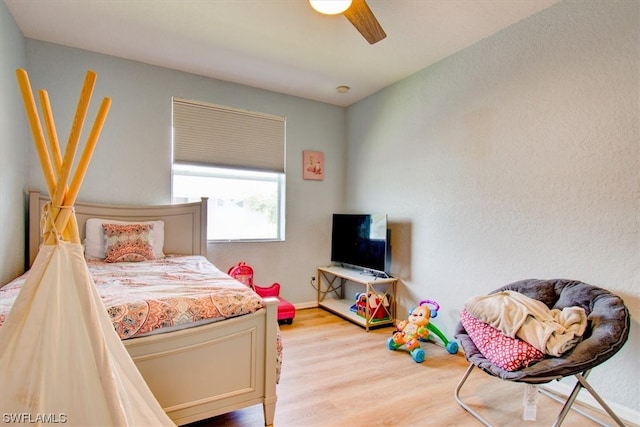 bedroom with light hardwood / wood-style floors and ceiling fan