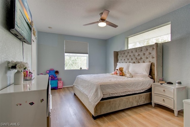 bedroom with light hardwood / wood-style floors and ceiling fan