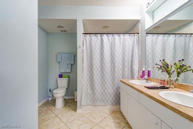 bathroom with double sink, tile flooring, oversized vanity, and toilet