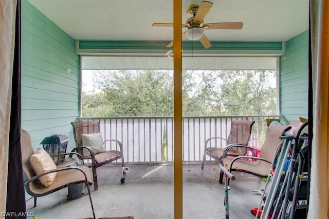 sunroom / solarium with plenty of natural light and ceiling fan