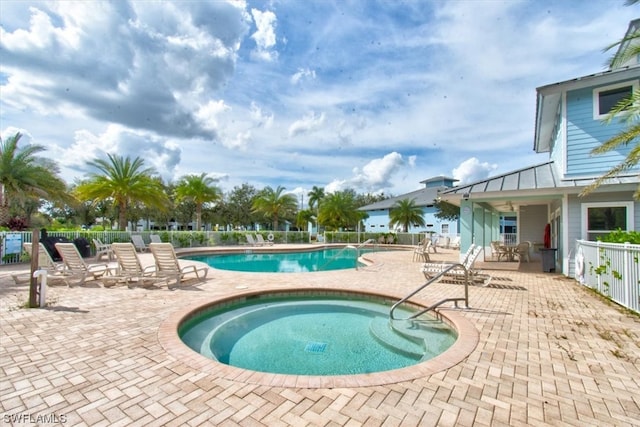 view of pool with a hot tub and a patio area