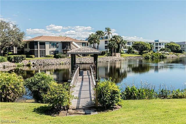 dock area featuring a yard and a water view